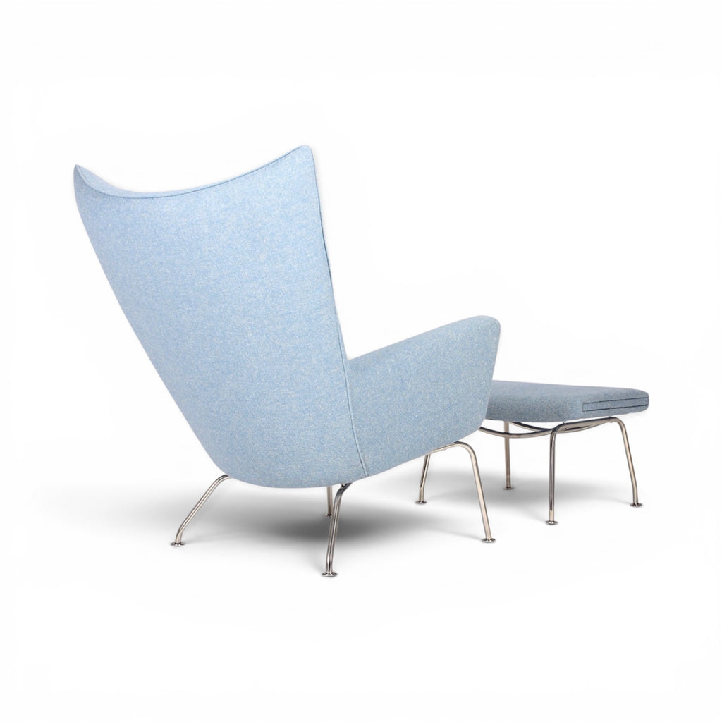 Modern light blue chair with a unique design on a white background