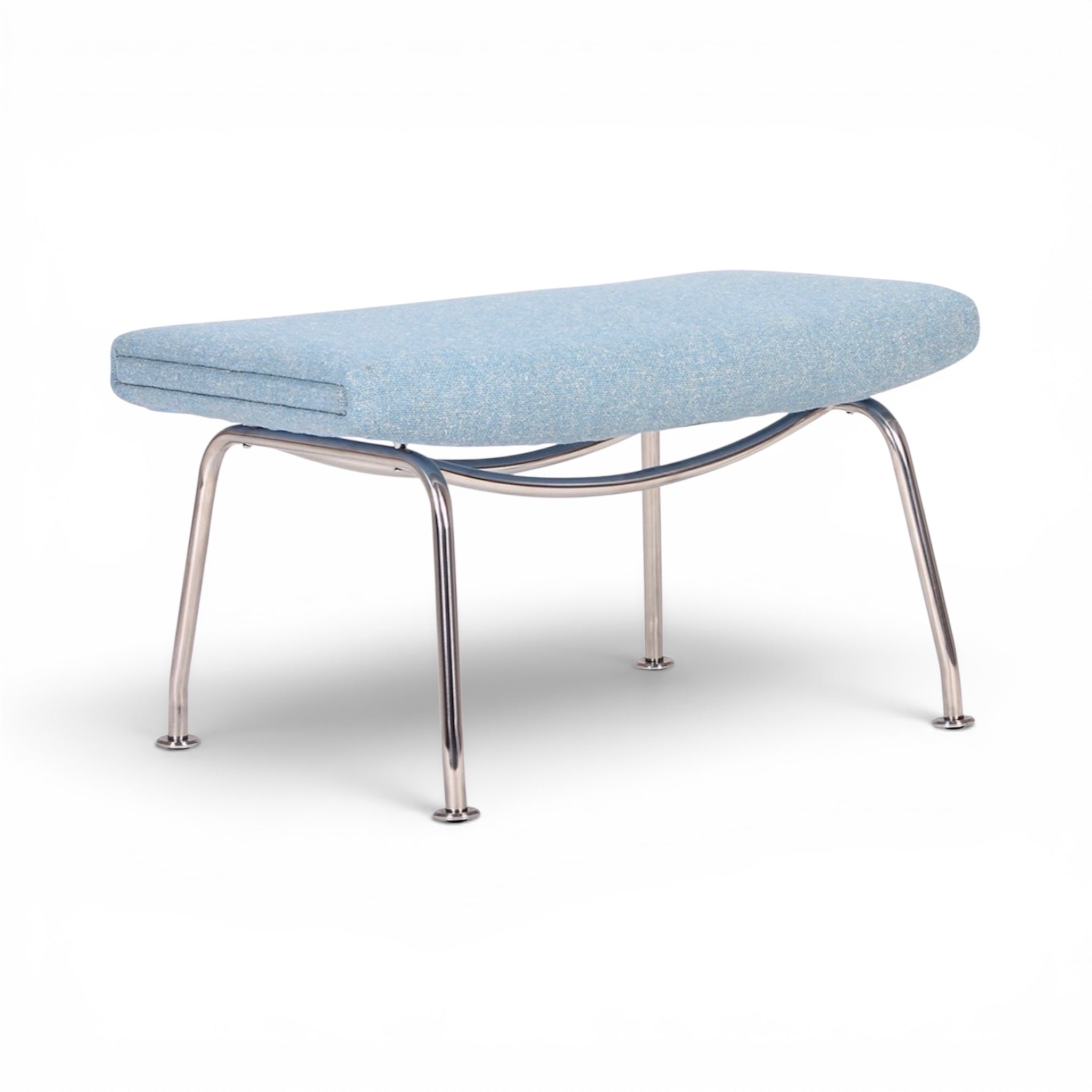 Light blue upholstered bench with metal frame on a white background