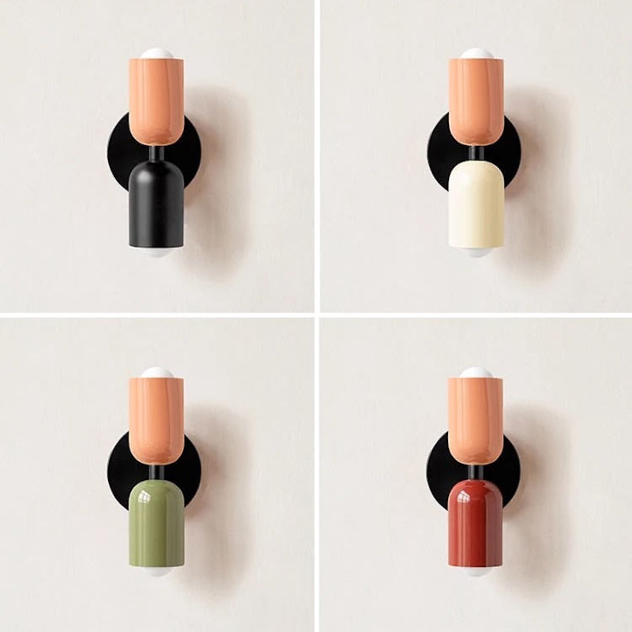 Four wall sconces with different colored cylindrical shades on a white background